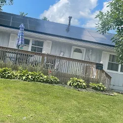 Solar panels on a white ranch home